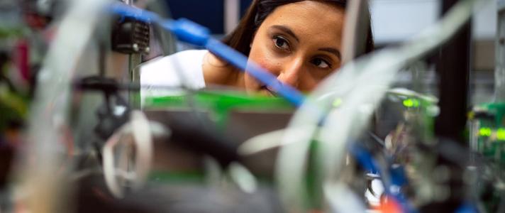 Woman looking closely at wires