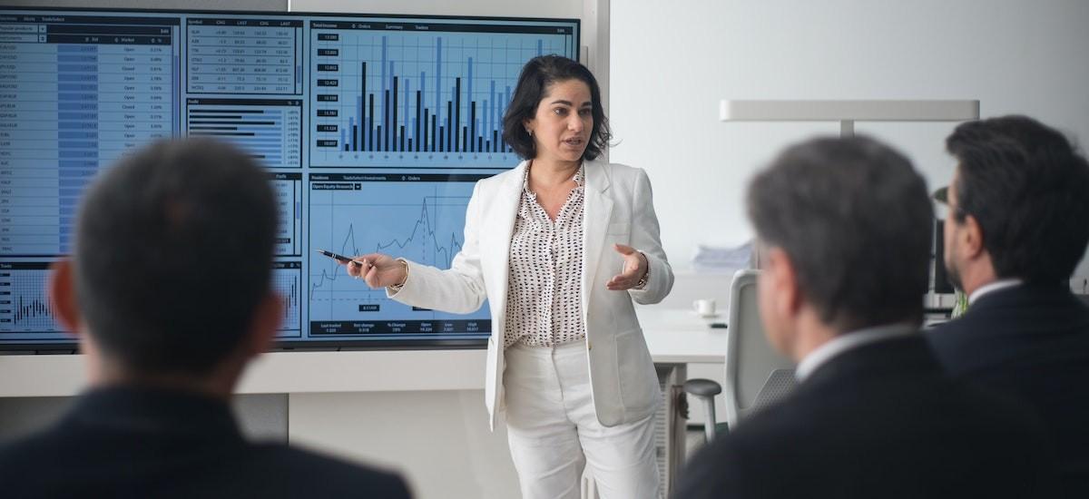 Woman presenting on an interactive whiteboard