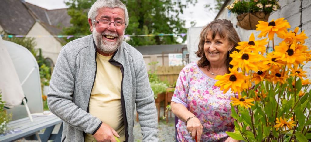 Man and women in an allotment gardening