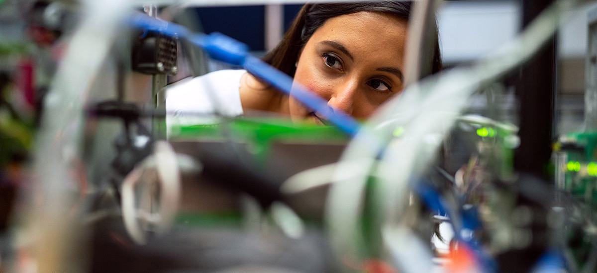 Woman looking closely at wires
