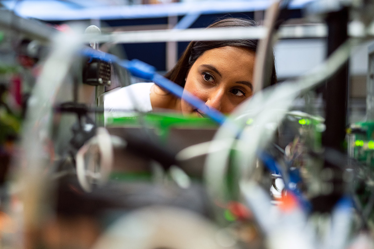 Woman looking closely at wires